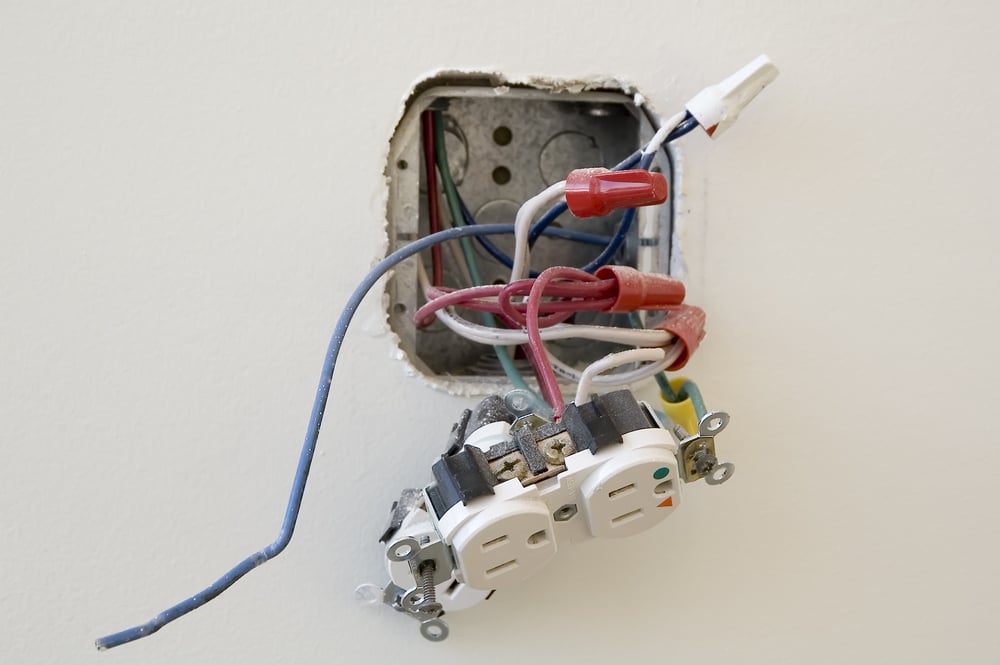 Electrical outlet during installation in office wall